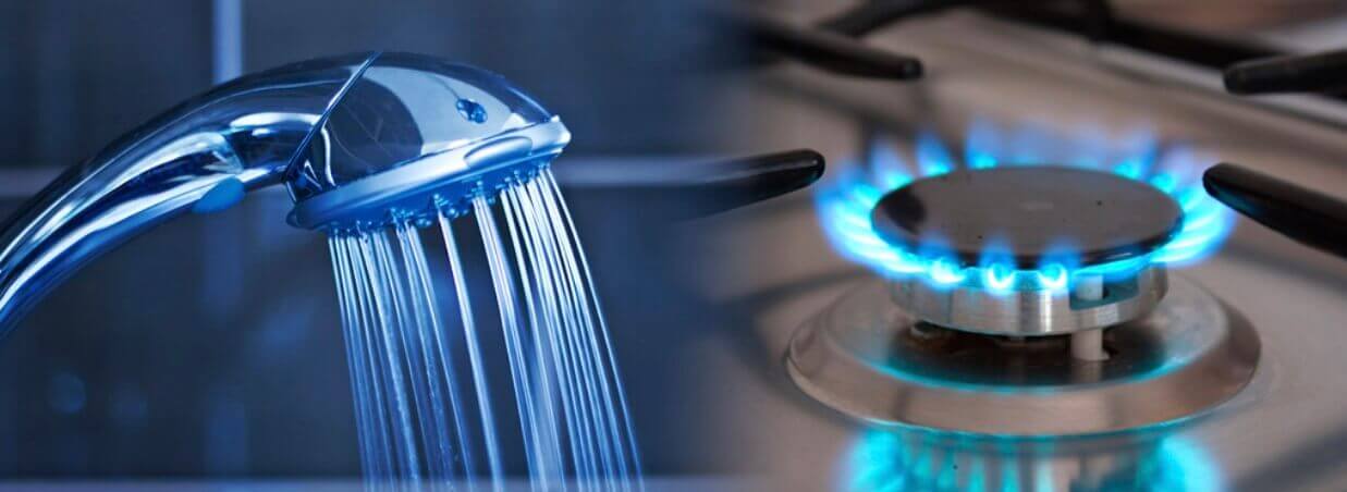 Water coming out of shower mixer and gas hob burner turned on with flame
