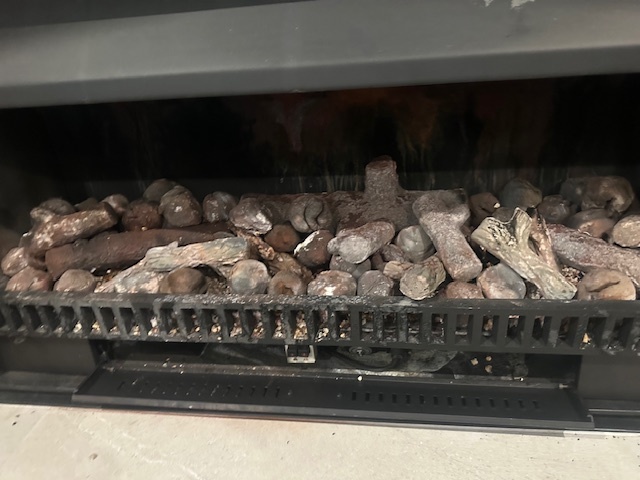 Close up of gas fire showing logs before the refurbishment