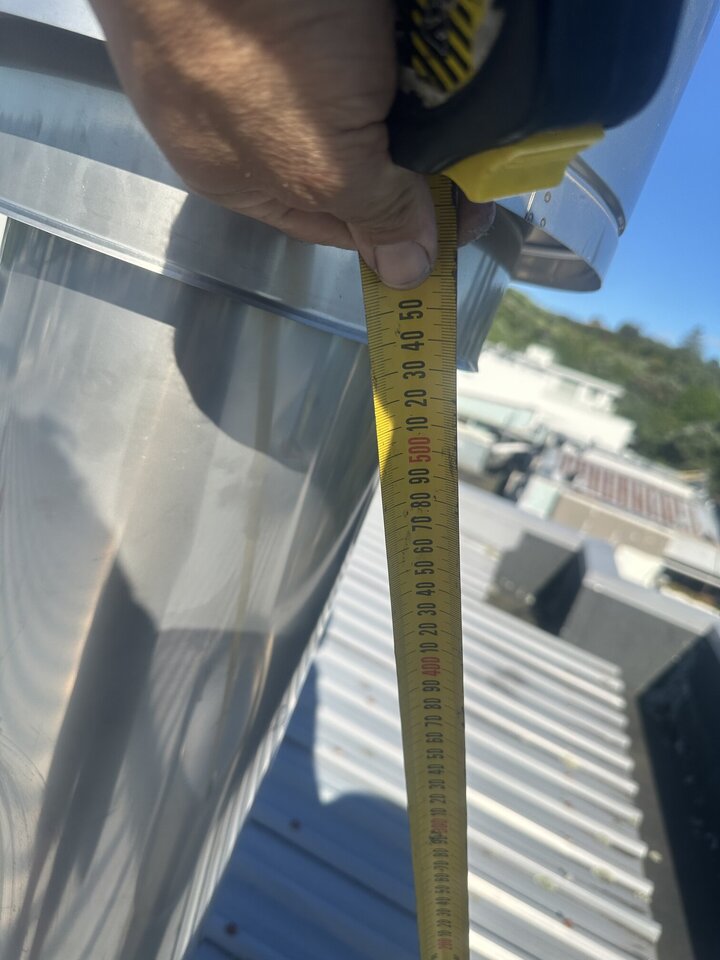 Jason measuring the flue on roof top