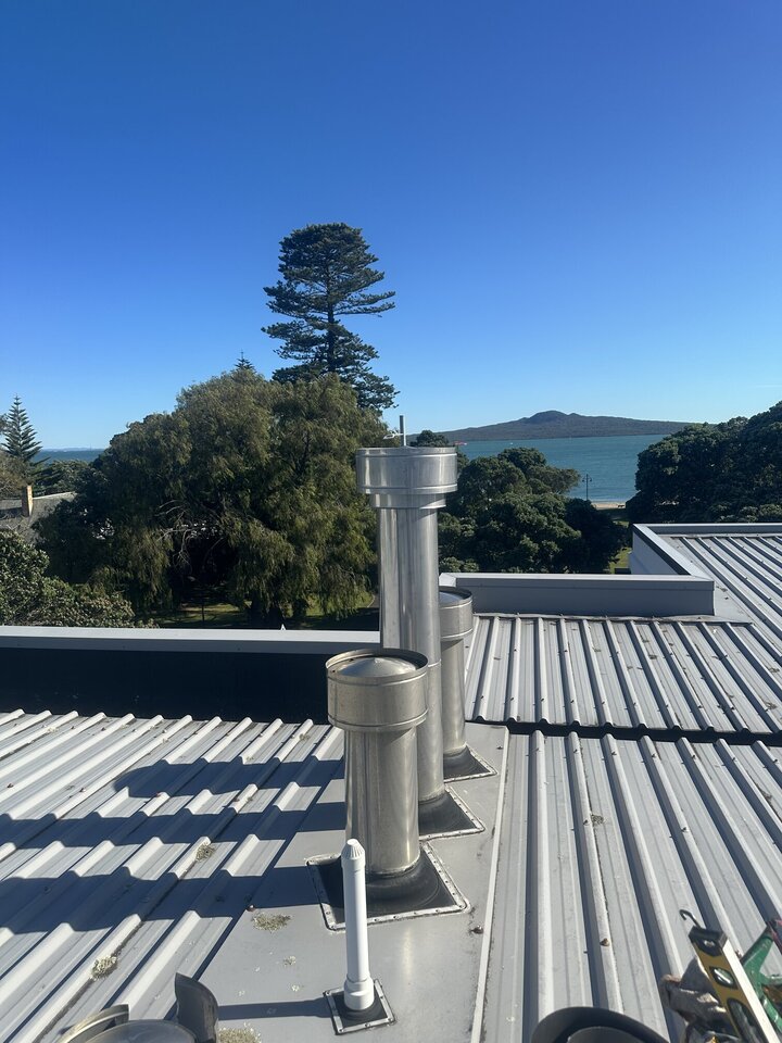 Gas cowls on top of roof with view of Rangitoto Island