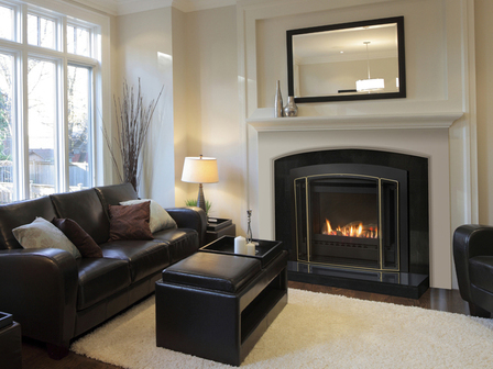 Gas fire in lounge with leather lounge suite and coffe table and lamp